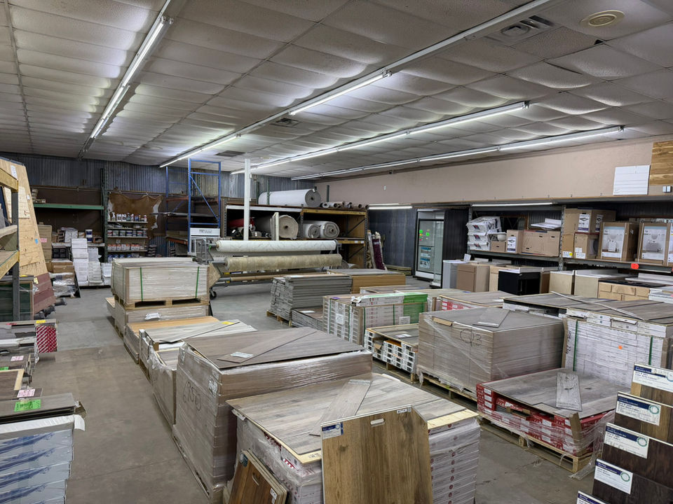 Warehouse interior with stacks of flooring materials on pallets