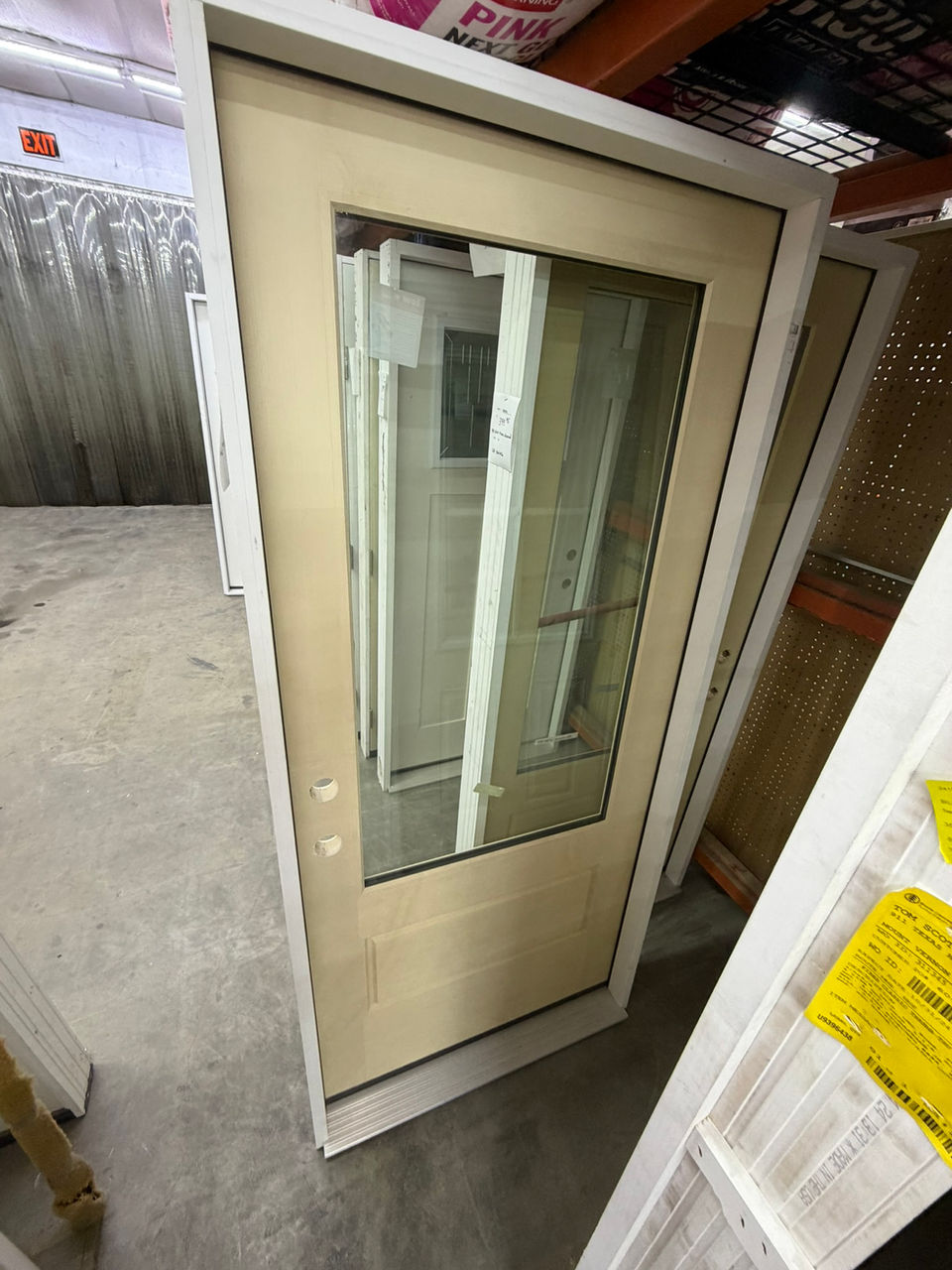 White exterior door with large glass pane in warehouse showroom