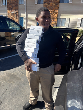 Amoor Consulting Group sales rep carrying a stack of phone boxes after a successful sales day