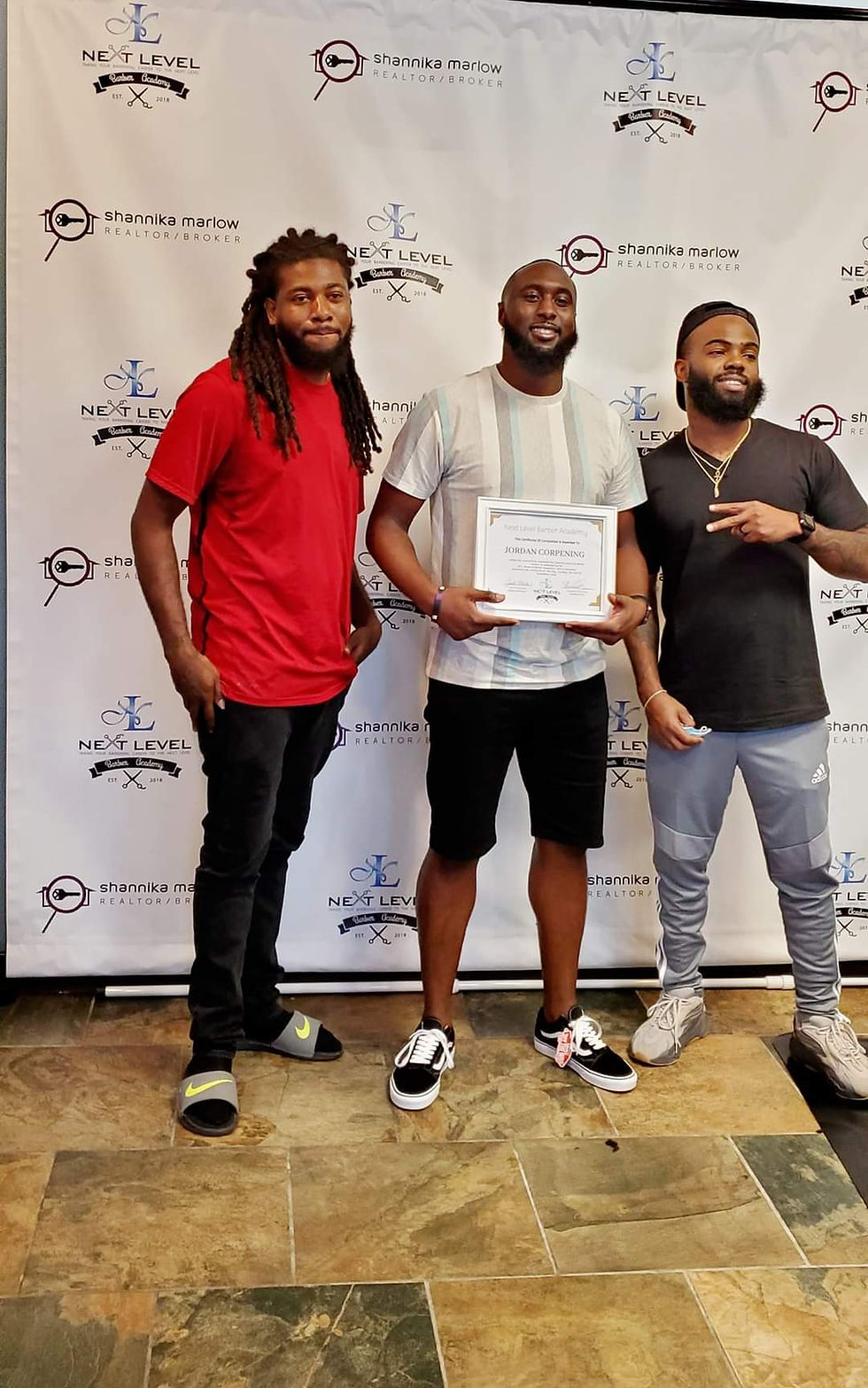 Nlbagaston students holding theirs graduation certificate with the CEO