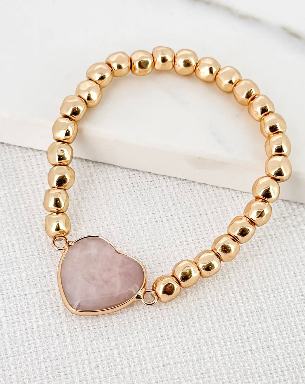 Gold alloy bead stretch bracelet with pink semi precious stone heart