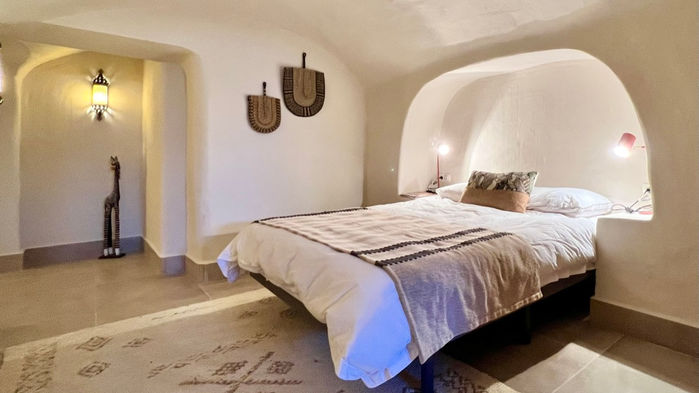 large bedroom, wall art, bed, pillows, bedding