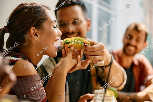 stock-photo-young-woman-eating-her-boyfriend-s-tacos-during-a-lunch-in-mexican-restaurant-