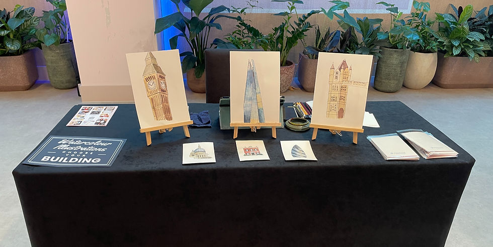 A table display of watercolour illustrations showcasing paintings of buildings