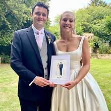 Wedding couple, holding up a painting of themselves