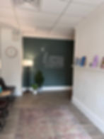 therapy waiting room with wall that says "Spring Village Center for Therapy and Wellness"