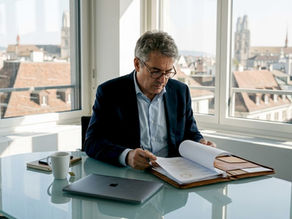 Businessman reviewing confidential documents in office