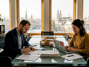 Entrepreneurs prepare Swiss GmbH documents in Zurich office