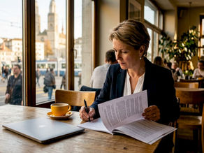 Businesswoman reviewing Swiss data privacy laws at office desk