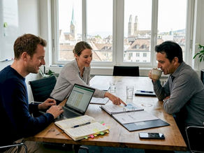 Swiss business team reviewing compliance documents