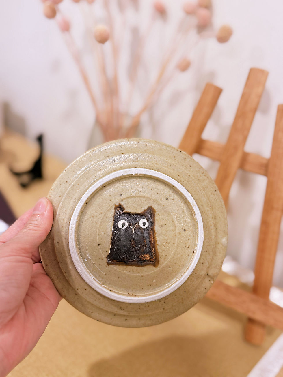 Black cat detail on base of Haruko Harada ceramic plate