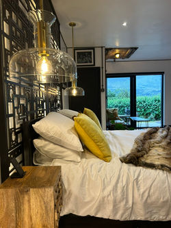 A super-king bedroom at The Brass Goat, Glenariff, looking out over the glen