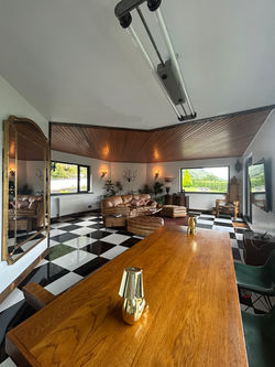 The Loft — the open-plan living and dining room, with the glen beyond