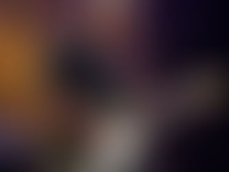 man standing on stage playing electric guitar