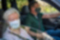 Senior woman and son with face mask driving in the car.jpg