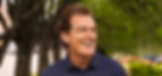 A happy and healthy male walking through a park