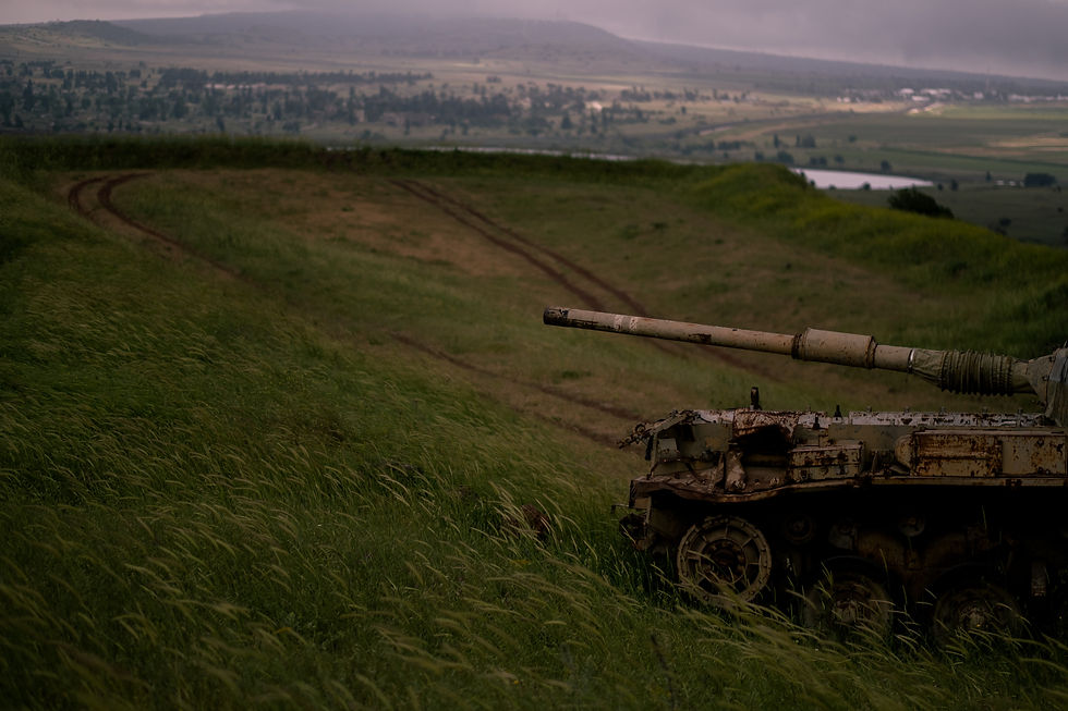 Rusted Syrian tank and military trenches at Mount Bental lookout overlooking the Golan Heights valley.