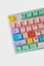 Colorful keyboard with pastel keys labeled with unique functions like "Save" and "Quit." Yellow, pink, and green tones dominate. Playful mood.