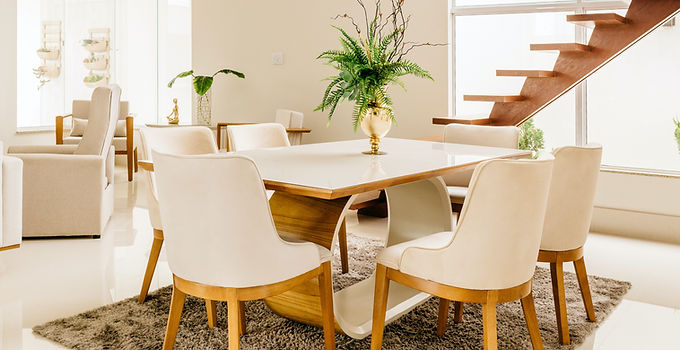 Cream upholstered dining chairs with wooden legs in a modern dining area