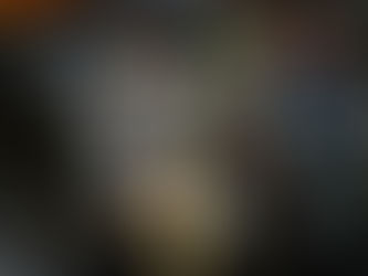 Colorful ceramic flowers protrude from water, reflecting vivid hues of blue, orange, and red, creating an artistic, serene atmosphere.