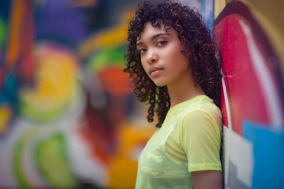 woman standing against graffiti wall
