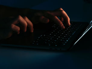 Fingers typing on a computer keyboard