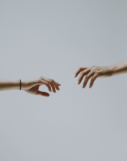 Two hands reaching out toward each other, symbolizing support, hope, and outreach consultation during a funeral repatriation dispute.