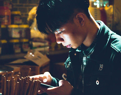 Man in light of mobile phone