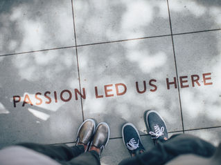 A sidewalk inlaid with the words "Passion led us here"