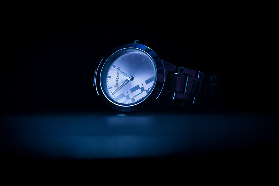 A luxury dive watch glowing against a dark background
