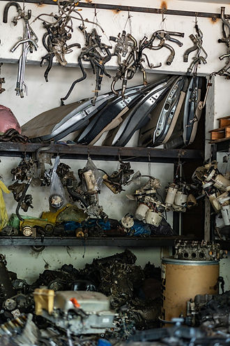 Automotive scrap metal components organised on metal shelving units
