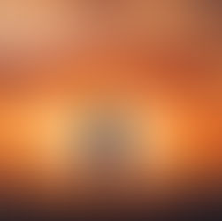 Man standing on a beach, embracing a golden sunset.