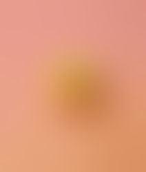 Close up picture of a whole grapefruit with a pink-ish yellow gradient background