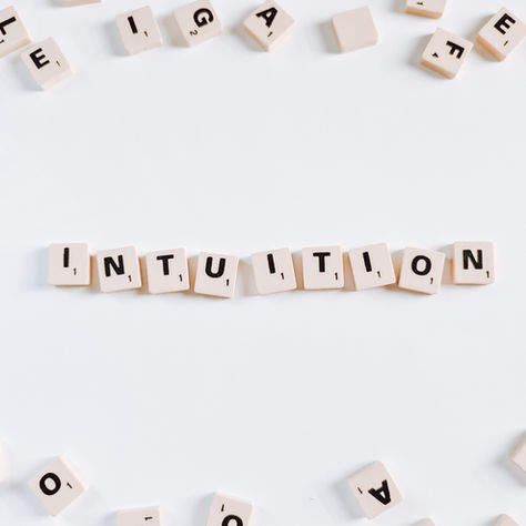 the word intuition spelled with woodden letters