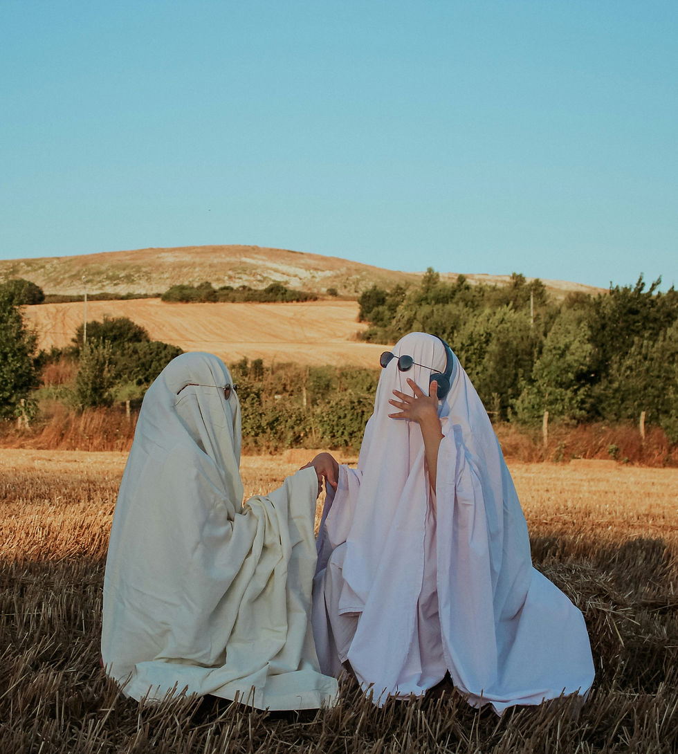 Two friendly ghosts enjoy a sunny field, foreshadowing the disappearing act soon to come in their dating life.