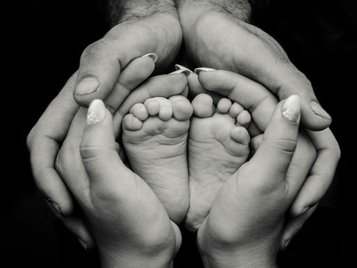 hands holding baby feet