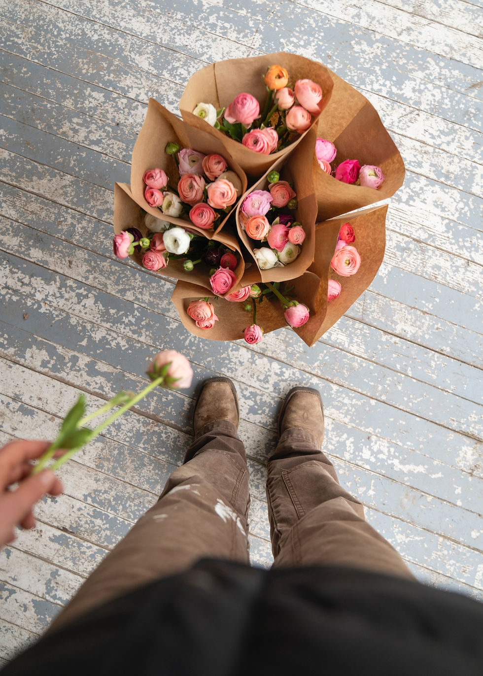 High angle view of a flower vendor arranging a bouquet