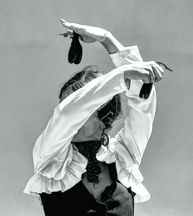 Black-and-white image of a woman performing a powerful Flamenco dance, capturing the dramatic movement, emotion, and timeless spirit of Spanish culture