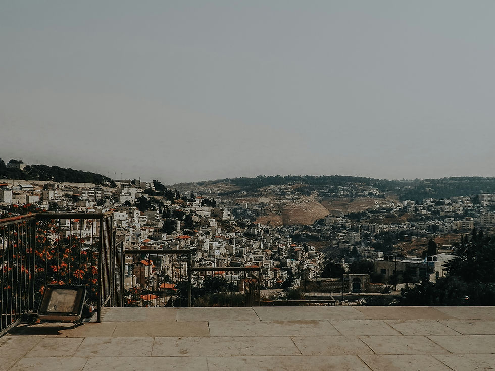 Panoramic view of the City of David ridge and the surrounding hills of Jerusalem from a stone terrace.