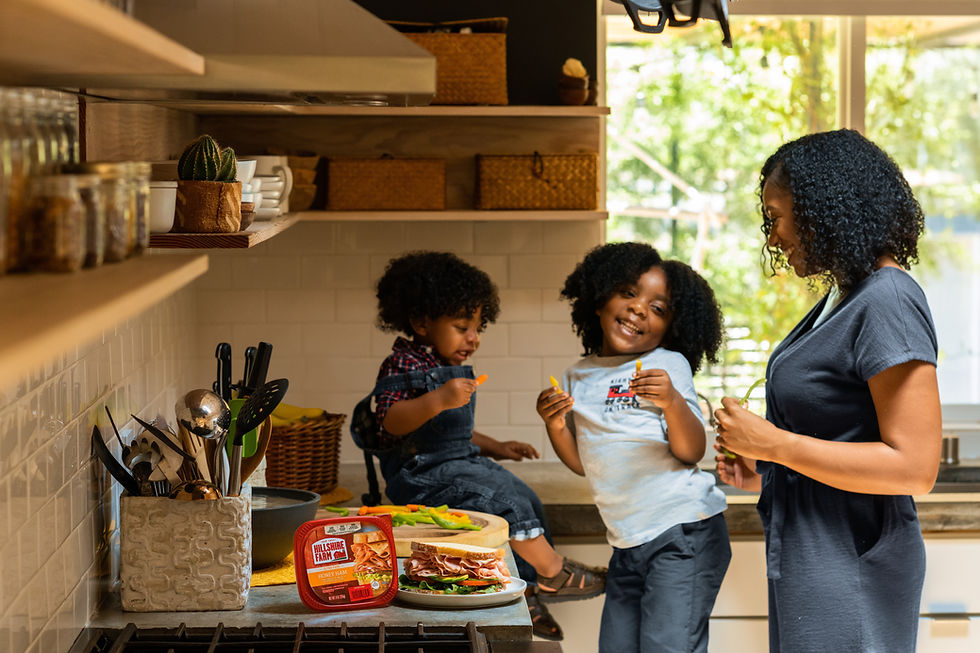 Mother and two children sharing a meal in a kitchen