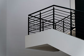 modern black metal balcony balustrade on white exterior wall