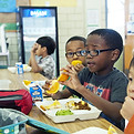 Young children eating school cafeteria food