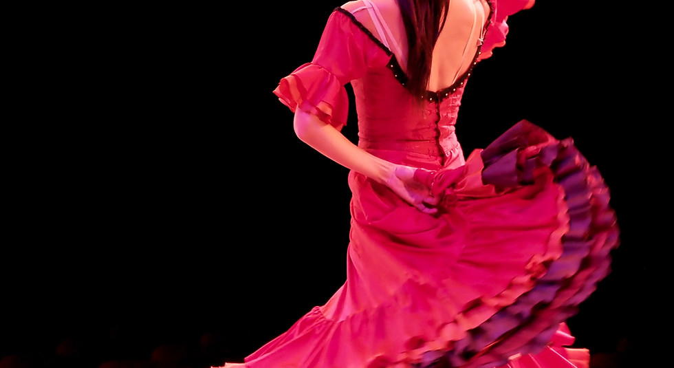 Elegant Spanish woman performing a passionate flamenco dance in a traditional red dress
