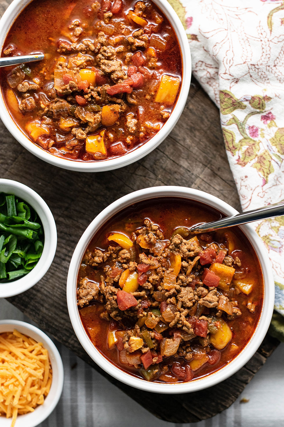 2 bowls of chili with cilantro and cheese