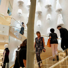 Luxury retail team in a refined boutique training environment discussing brand storytelling and client experience.