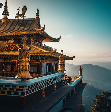 Majestic Golden Roof Buddhist Shrine gleaming under sunlight, featuring intricate golden carvings, traditional Bhutanese architecture, and surrounded by serene mountains, reflecting the spiritual and cultural richness of Bhutan