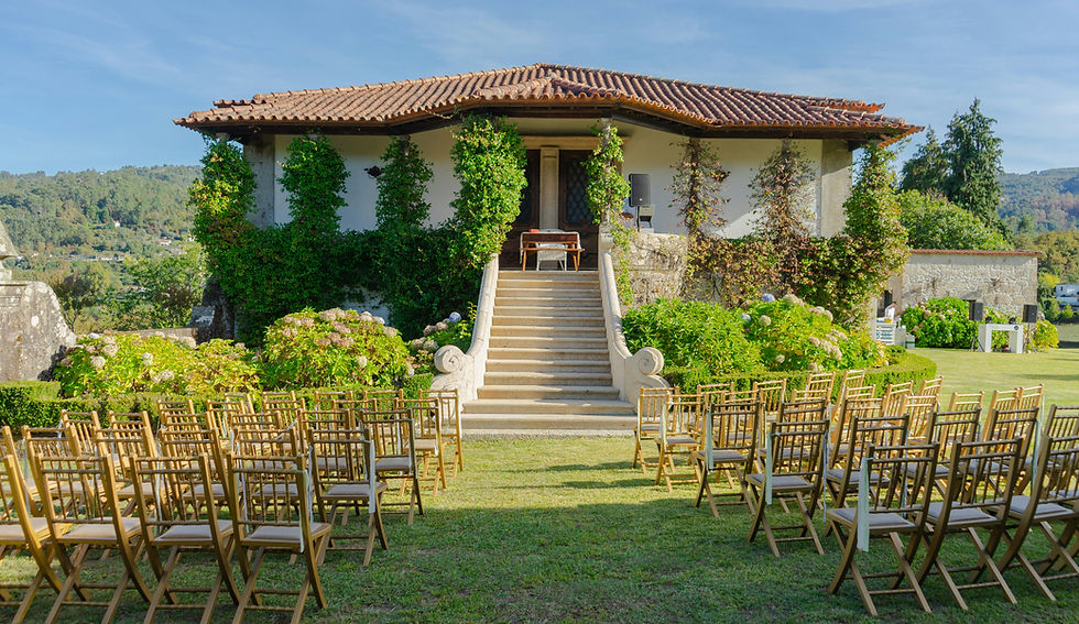 An elegant outdoor wedding venue set amidst lush greenery, offering an intimate and serene atmosphere for a memorable celebration.