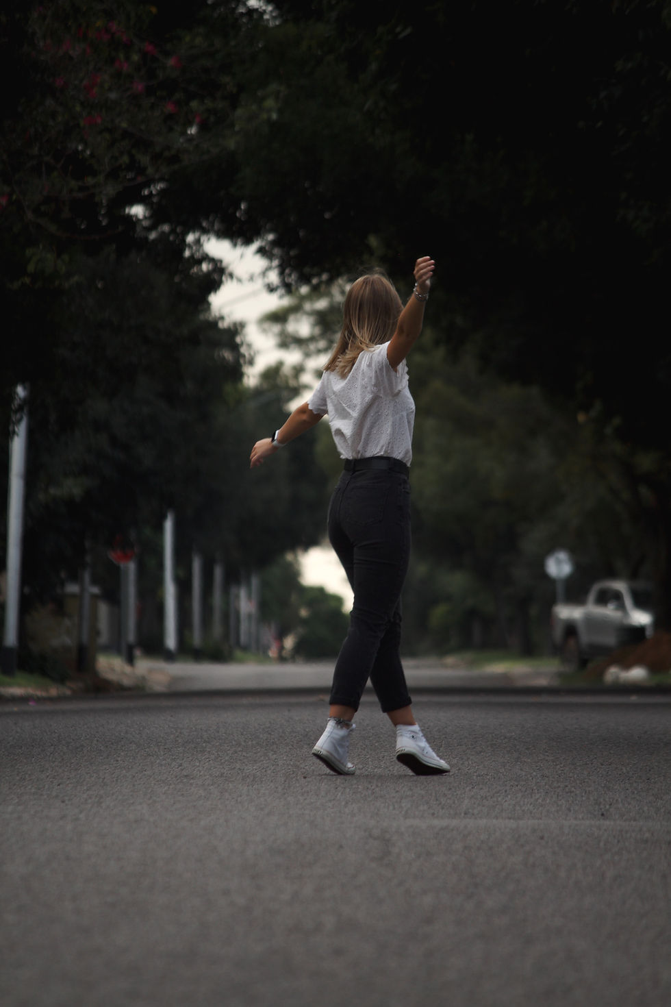 Woman dnacing in the middle of the stress. She's taking a break from daily life. She's free and fun and balanced.