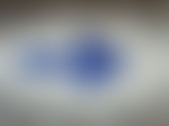 Blue painter's tape on the floor in the shape of an arrow