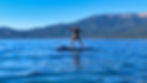 Woman performing a yoga pose on a paddle board on a lake